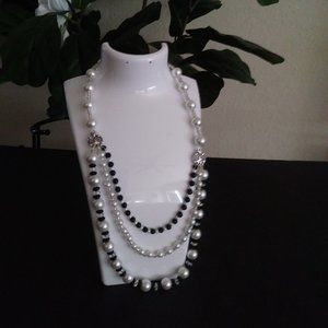 Handmade crystal bead necklace with three rows of white pearls.